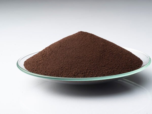 Close-up of LANXESS Iron Oxide Brown 4668 powder on a glass plate.