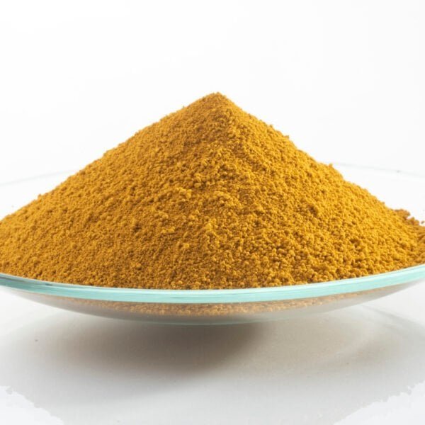 Yellow iron oxide pigment on a clear glass dish for industrial use.